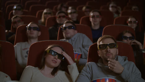 Spectators-in-3D-glasses-strained-watching-scary-flm.-Audience-in-3d-cinema