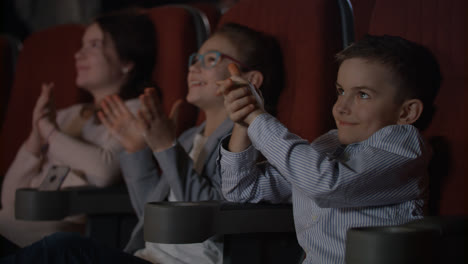 Satisfied-children-applauding-in-cinema.-Storm-of-applause-in-cinema