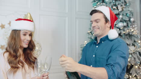 Laughing-couple-celebrating-new-year-with-sparkling-wine.
