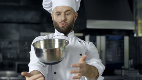 Chef-playing-with-bowl.-Chef-man-preparing-to-cook-at-professional-kitchen.