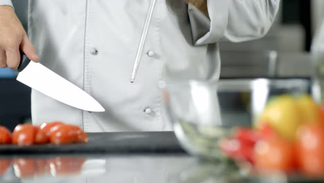Male-chef-sharpening-knife-in-slow-motion.-Closeup-chef-hands-preparing-to-cook.