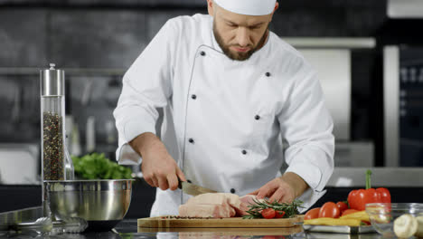 Chef-cutting-pork-fillet-at-kitchen.-Man-chef-preparing-meat-in-slow-motion
