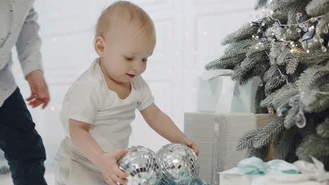 Small-boy-playing-mirror-balls-in-living-room.-Two-boys-touching-disco-balls