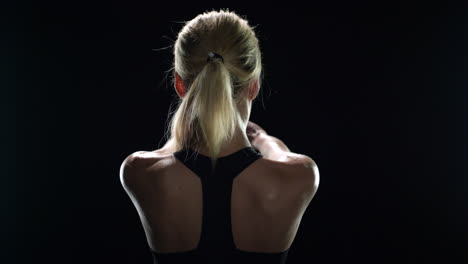 Back-view-of-sport-woman-training-stretch-exercise-in-gym.-Fit-girl-warming-up