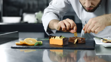 Chef-cooking-cake-at-workplace.-Closeup-male-hands-decorating-dessert