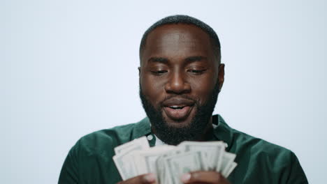 Portrait-of-happy-african-american-man-counting-money-on-grey-background.