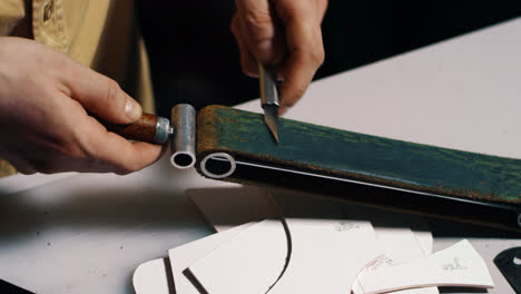 Craftsman-sharpening-stencil-knife-with-leather-sharpener
