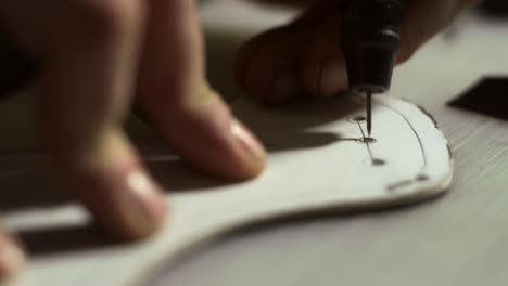 Artisan-man-making-holes.-Close-up-leather-craftsman-hands-working-with-leather