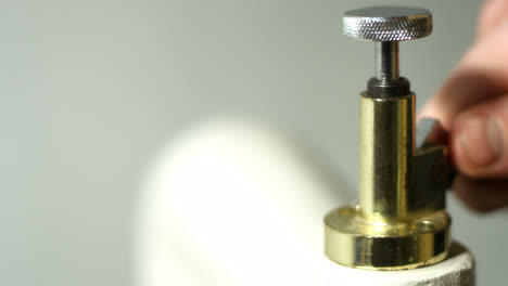Handicraftsman-adjusting-press.-Close-up-man-hand-rotating-adjusting-screw