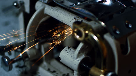 Sparks-while-grinding-iron-in-workshop.-Close-up-working-grinding-machine