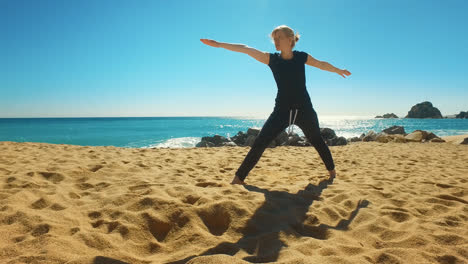 Woman-practicing-yoga-asana-on-coast-of-sea.-Fit-girl-doing-flexibility-exercise