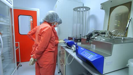 Pharmaceutical-manufacturing-workers-check-factory-equipment