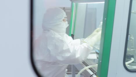 Scientist-in-protective-suit-working-at-laboratory.-Pharmacological-technologies