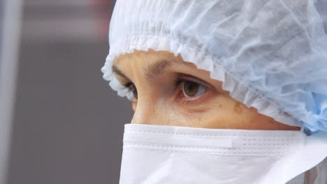 Laboratory-worker-face-in-protective-mask-looking-away.-Doctor-face-in-mask