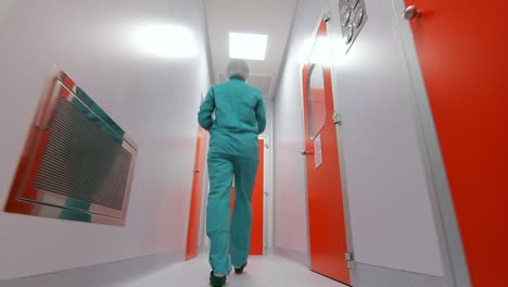 Scientist-entering-laboratory-room.-Pharmaceutical-worker-walking-white-corridor
