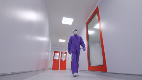 Pharmacist-moving-in-laboratory-corridor.-Scientist-walking-lab-corridor