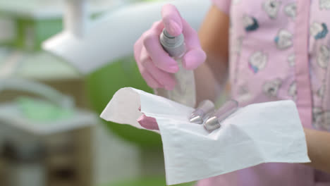 Dentist-disinfecting-dentistry-tools.-Doctor-hands-preparing-dental-equipment