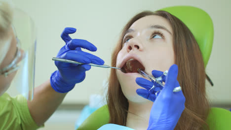 Young-woman-with-open-mouth-during-dental-procedure.-Anesthetic-injection