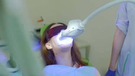 Teeth-whitening-procedure-in-dental-office.-LED-whitening-light-bleaching-teeth