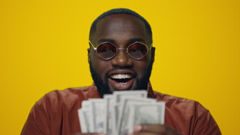 Porträt-Eines-Glücklichen-Afroamerikaners,-Der-Auf-Gelbem-Hintergrund-Geld-Zählt.
