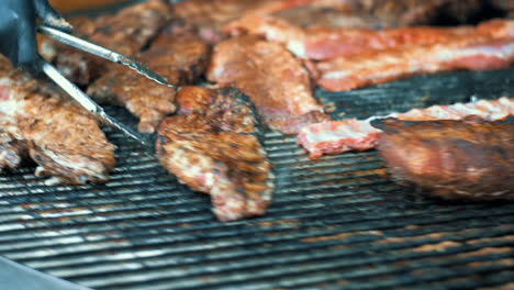 Closeup-man-hands-cooking-lamb-ribs-on-barbeque-grill.-Man-grilling-meat.