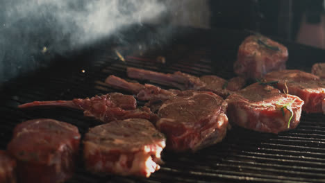 Closeup-man-hands-cooking-meat-outside.-Chef-putting-beef-ribs-on-grill
