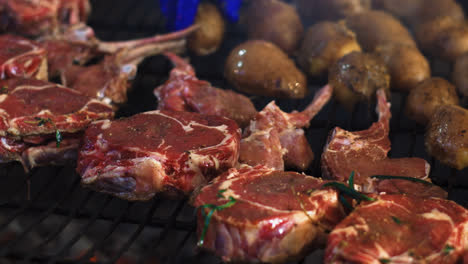 Closeup-chef-hands-cooking-beef-ribs-with-vegetables.-Potatoes-on-grill.