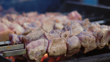 Closeup-beef-shish-kebabs-grilling-outdoor.-Pork-shashlik-barbecuing-for-picnic.