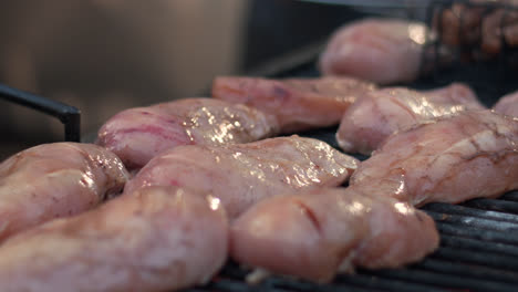Closeup-raw-chicken-breast-preparing-on-grill-outdoor.