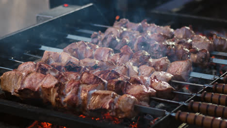 Closeup-pork-kebabs-barbecuing-at-brazier-outdoor.