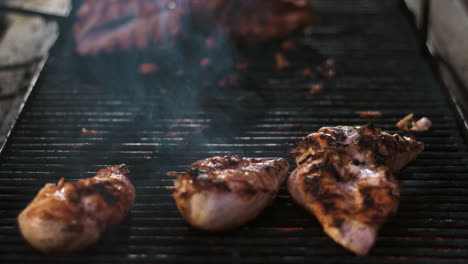 Closeup-chicken-fillet-grilling-outdoor.-Tasty-chicken-meat-roasting-on-grill.
