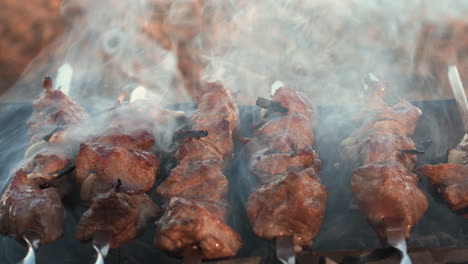 Closeup-smoked-bbq-cooking-on-brazier-outdoor.-Pork-kebabs-roasting-on-charcoal