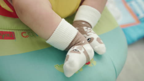 Baby-feet-in-socks.-Close-up-of-little-foot-in-funny-socks.-Sweet-feet-socks
