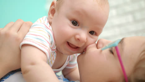 Happy-girl-kissing-baby-boy.-Close-up-of-girl-hug-infant
