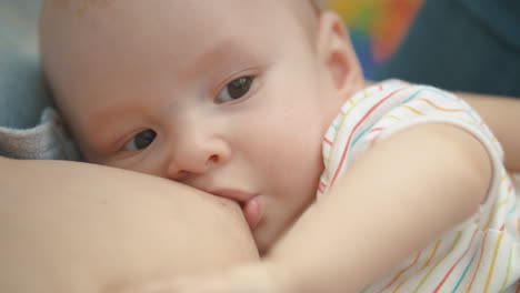 Breast-feeding-baby-portrait.-Motherhood-love.-Lovely-baby-breast-feeding