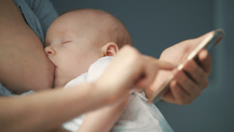 Breastfeeding-mother-using-mobile-phone.-Breast-feeding-mom-work-on-smartphone