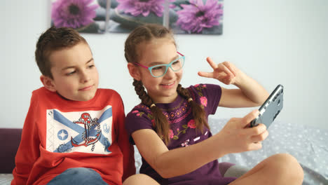 Teenager-kids-taking-mobile-selfie.-Cheerful-children-making-selfie-at-home