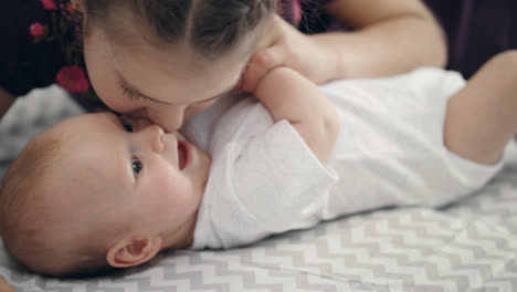 Girl-kissing-baby-boy.-Sister-kiss-little-brother.-Sweet-kids-love-concept