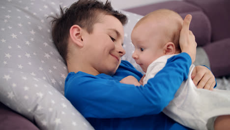 Boy-care-baby.-Sweet-childhood.-Adorable-kids-love.-Older-brother-embrace-kid