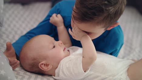 Innocent-child-love.-Close-up-of-older-brother-playing-with-baby-boy
