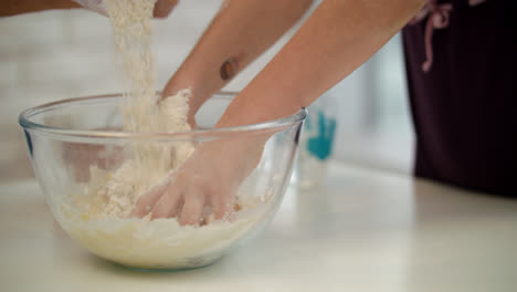 Child-hands-cooking-dough.-Girl-hand-preparing-dough.-Daughter-preparing-cake
