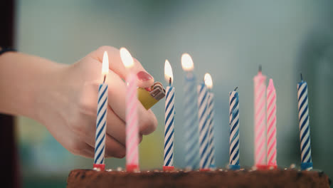 Geburtstagstorte-Mit-Kerzen.-Weibliche-Hand-Zündet-Kerzenfeuer-Mit-Leichterer-Flamme-An