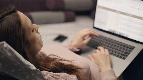 Business-woman-browsing-data-report-on-laptop-computer-screen-online-at-home