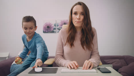 Stressed-woman-at-freelance-work.-Children-interrupt-busy-parent