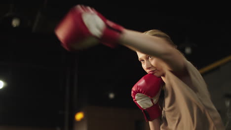 Attractive-fit-girl-boxing-in-fitness-center.-Sport-woman-doing-punches-at-gym