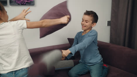 Kids-fight-with-pillows-at-home.-Children-fighting-with-fun-at-home
