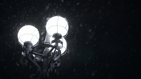 Street-lamp-glowing-in-snowy-night.-Close-up-street-light-in-winter-snowflakes