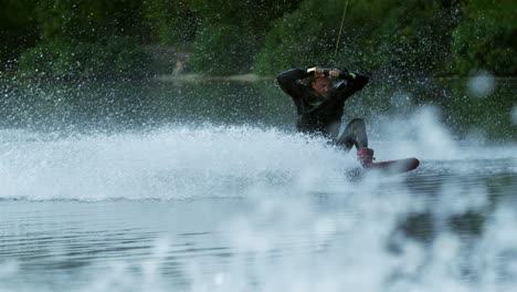 Wakeboarder-making-tricks-on-waves-during-movement-in-slow-motion.-Extreme-sport