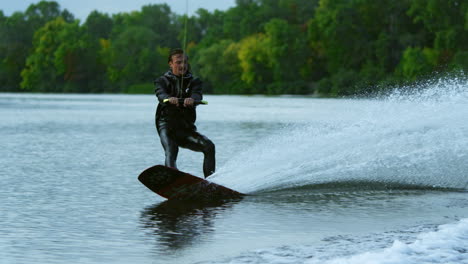 Man-wakeboarding-on-river.-Water-sport-activity-in-slow-motion