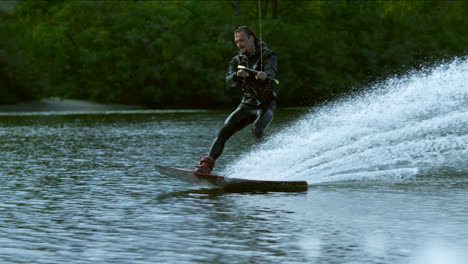 Wake-boarding-on-river.-Male-rider-enjoy-wakeboarding.-Extreme-lifestyle